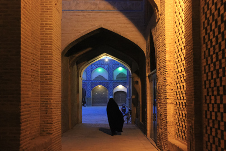 iranian women in black chador on the esfahan street at eveningの写真素材