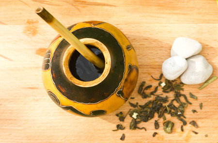 herbal tea mate with flowers and stones  on cutting wooden boardの写真素材