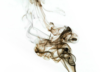 black smoke from aromatic indian sticks on a white backgroundの写真素材