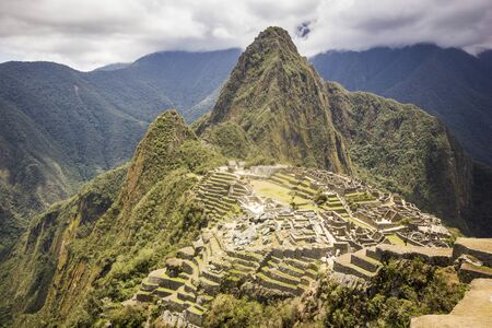 self-portrait of smiling young man in red t-short near old town of machu-picchu, peru