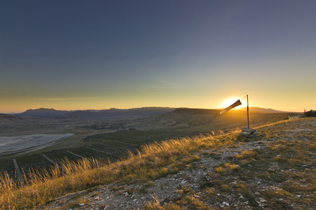 windsock at sunset in mountains against sunの写真素材