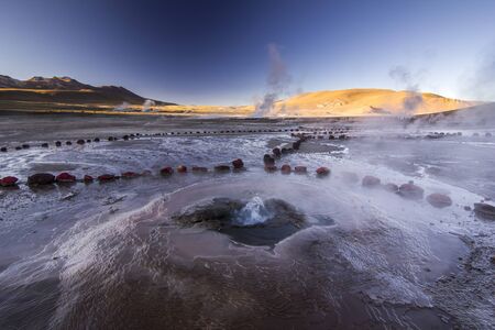 geyser tatio with water surface at sunriseの写真素材