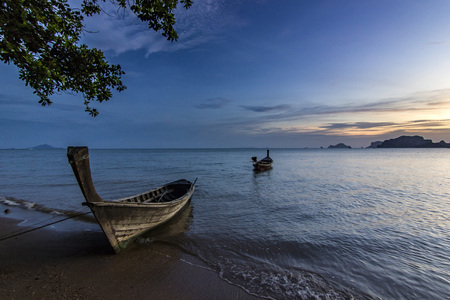 ocean seashore with island and boat on water at sunset in Krabi, Thailandの写真素材