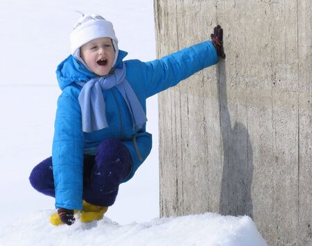 Young girl near the concrete wallの写真素材