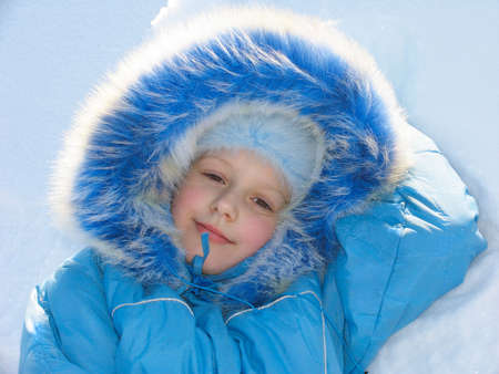 Winter portrait of young girl on snow