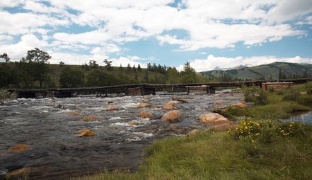 Wooden bridge over river Alash