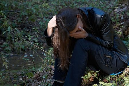 Girl crying  in the forest
