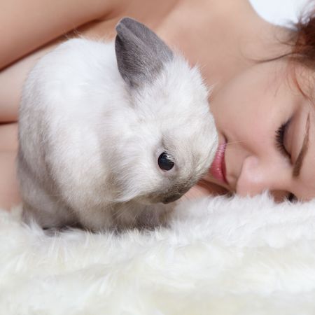 Girl sleeping with his pet pygmy rabbitの写真素材