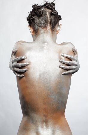 portrait of nude girl's back painted with silverの写真素材