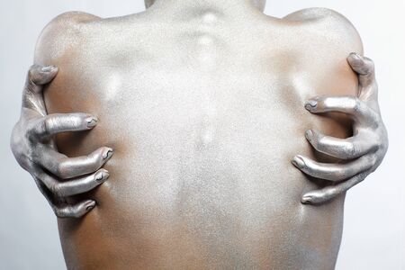 portrait of nude girl's back painted with silverの写真素材