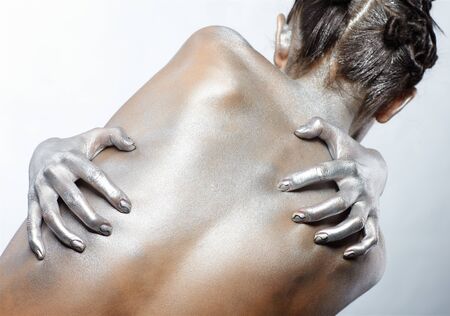 portrait of nude girl's back painted with silverの写真素材