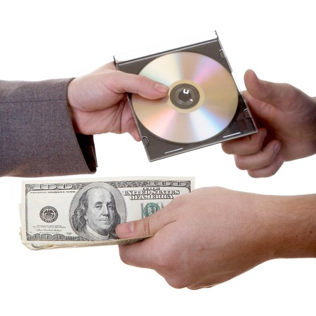 Man's hand with dollars and CD isolated at the white background