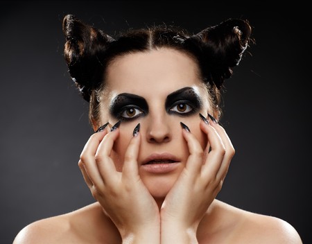 portrait of brunette girl with cat-theme make-upの写真素材