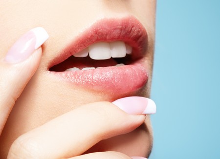 close-up portrait of beautiful girl's manicure and lips-zone make-upの写真素材