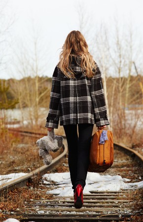 Girl walking along old railroadの写真素材