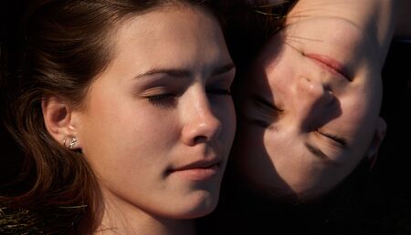 Girls sleaping on the grassの写真素材