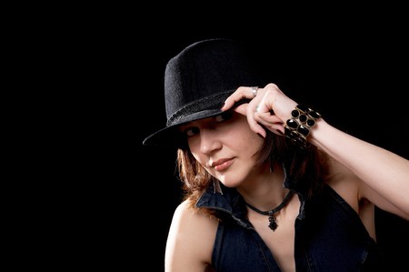 Young woman in hat isolated on the black background