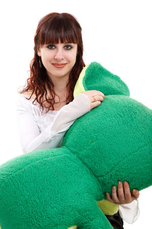 Portrait of brown-haired girl with her lovely toy on white background の写真素材