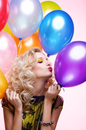 portrait of beautiful blonde girl with balloons celebrating birthdayの写真素材