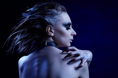 cold-tint portrait of beautiful girl with bird of prey make-up, hair-do and manicureの写真素材