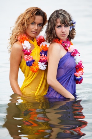 Young girls with flowers in the waterの写真素材
