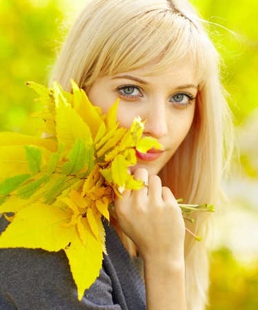 Autumn woman with yellow fall maple leavesの写真素材
