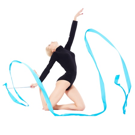 portrait of beautiful young blonde woman gymnast training calilisthenics exercise with blue ribbon on whiteの写真素材