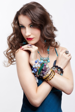 portrait of young beautiful brunette woman in blue dress and jewelleryの写真素材