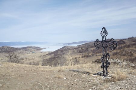Cross and lSiberian landscape near lake Baikal in Aprilの写真素材