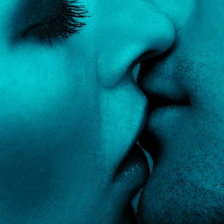 close up portrait of young caucasian couple kissingの写真素材