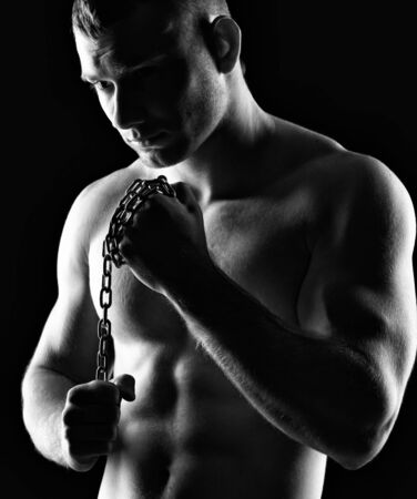 Silhouette of young athlete bodybuilder man on black の写真素材