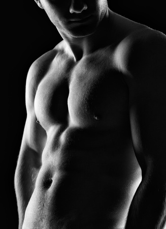 Silhouette of young athlete bodybuilder man on black の写真素材