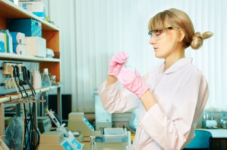 portrait of young woman scientist working in laboratory with retortの写真素材
