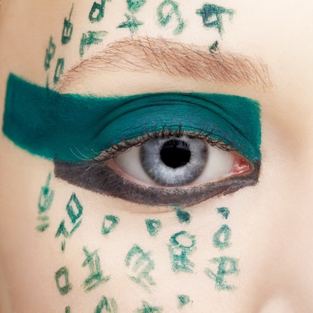 close up portrait of beautiful young woman with hieroglyphic bodyartの写真素材