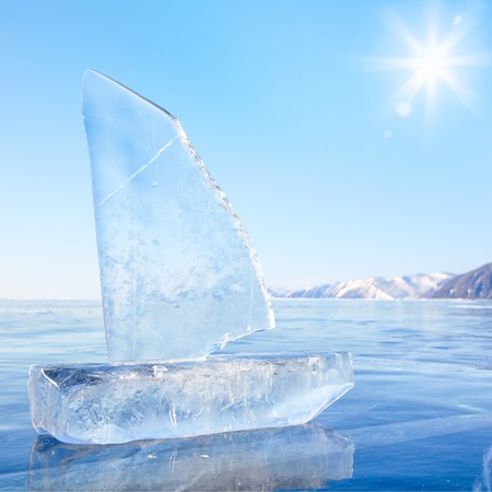 Yacht made of ice blocks on winter lake Baikal under Sun raysの写真素材