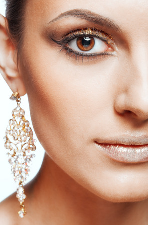 Close-up shot of female face with vogue golden shining eye makeupの写真素材