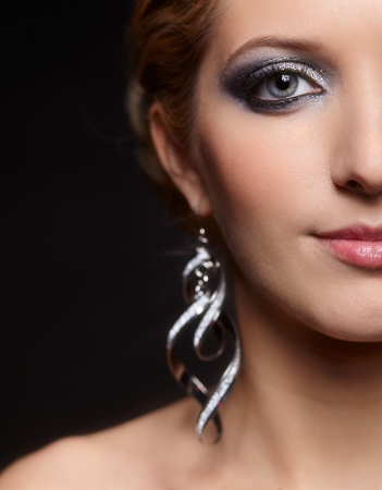 Beautiful young woman with vogue shining sparkle face makeup の写真素材