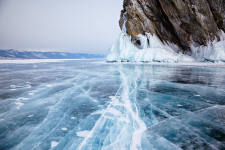 Rocks frozen into the ice of siberian Baikal Lake in winter
