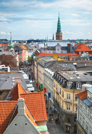 The view from the Round Tower on Copenhagen red roofs and the Tower of Nicolaj Kirke in the distance, Denmark.の写真素材