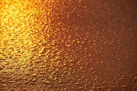 Shagreen wet sand at the time of sunset on Mai Khao beach in Phuket, Thailandの写真素材