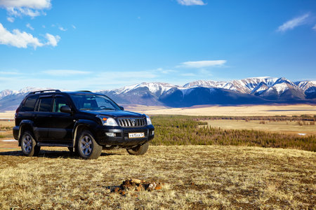 KURAI, RUSSIA - MAY 27, 2015: Black Land Cruiser Prado in Altai mountains in Kurai area with North Chuisky Ridge on background.のeditorial素材