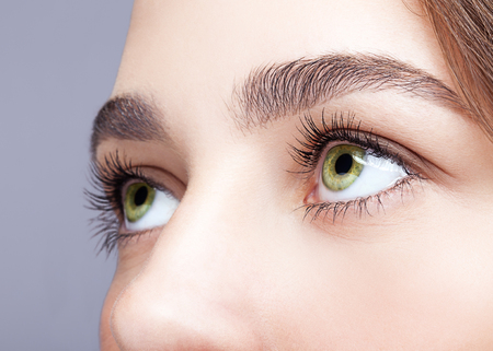 Closeup shot of female green pistachio colour eye  with day makeupの写真素材