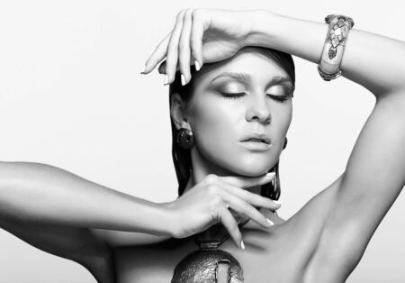 Portrait of young beautiful woman with wet shining  makeup and closed eyesの写真素材