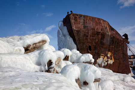 Old frozen ship on the bank of Olkhon island on siberian lake Baikal at winter timeの写真素材