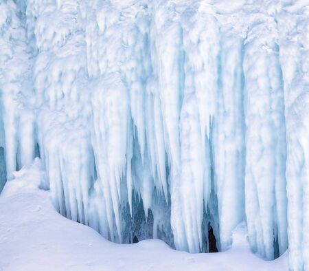 Icicles background on the ice wall on Baikal lake at winterの写真素材