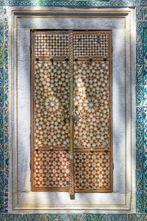 ISTANBUL, TURKEY - JULY 12, 2014: An inlaid mother-of-pearl doors in sunlight  in Topkapi palace Harem Hall with a Fountain, Istanbul , Turkeyのeditorial素材