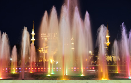 The evening illumination of fountain and Blue mosque with traditional mahya lights stretched across the minarets during the holy month of Ramadan, Istanbul, Turkeyの写真素材