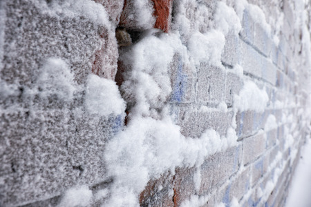Old frozen brick wall covered by hoarfrostの写真素材