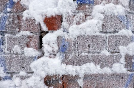 Old frozen brick wall covered by hoarfrostの写真素材