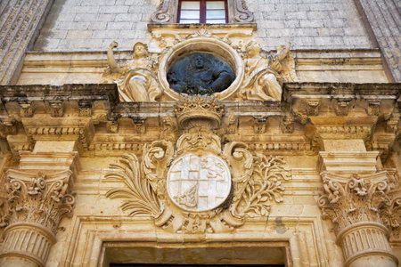 Decoration with the coats of arms and bas-relief of Antonio de Vilhena over the entrance to Palazzo Vilhena, now Museum of Natural History, Mdina, Maltaのeditorial素材